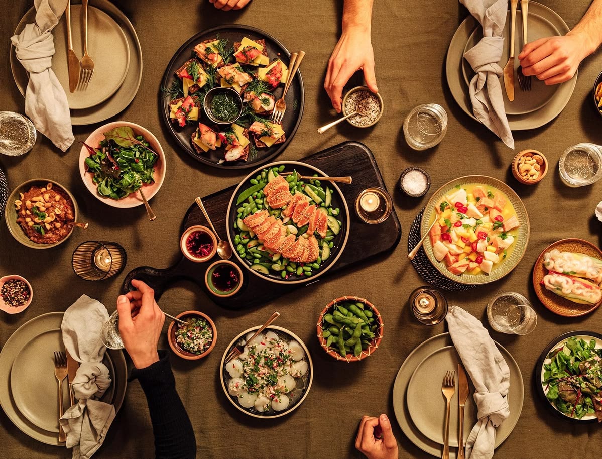 The Flexiblemoveeu team gathered around a table with seasonal produce in Queenstown